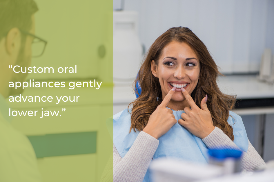 Woman sitting in a dental chair, smiling and pointing to her lower jaw; text on the image explains custom oral appliances and jaw advancement.